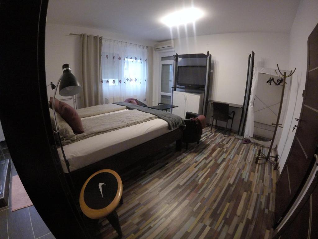 a bedroom with a bed and a television in it at Dózsaház in Zalaegerszeg