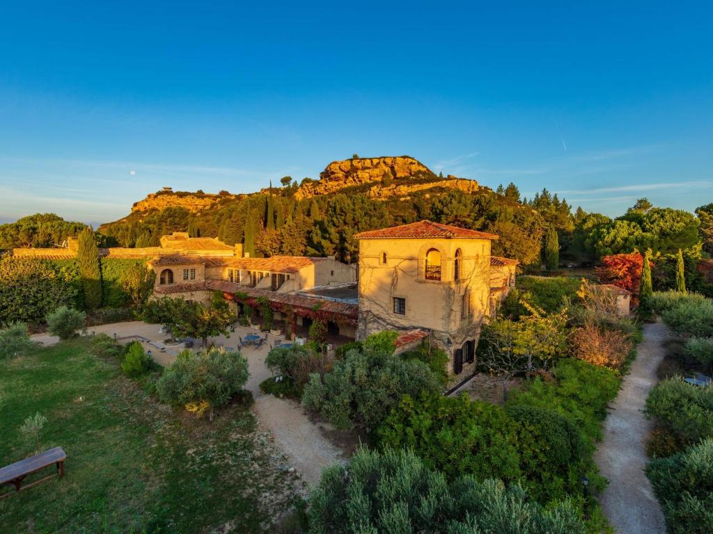 an aerial view of a building with a mountain in the background at Garrigae Abbaye de Sainte Croix in Salon-de-Provence