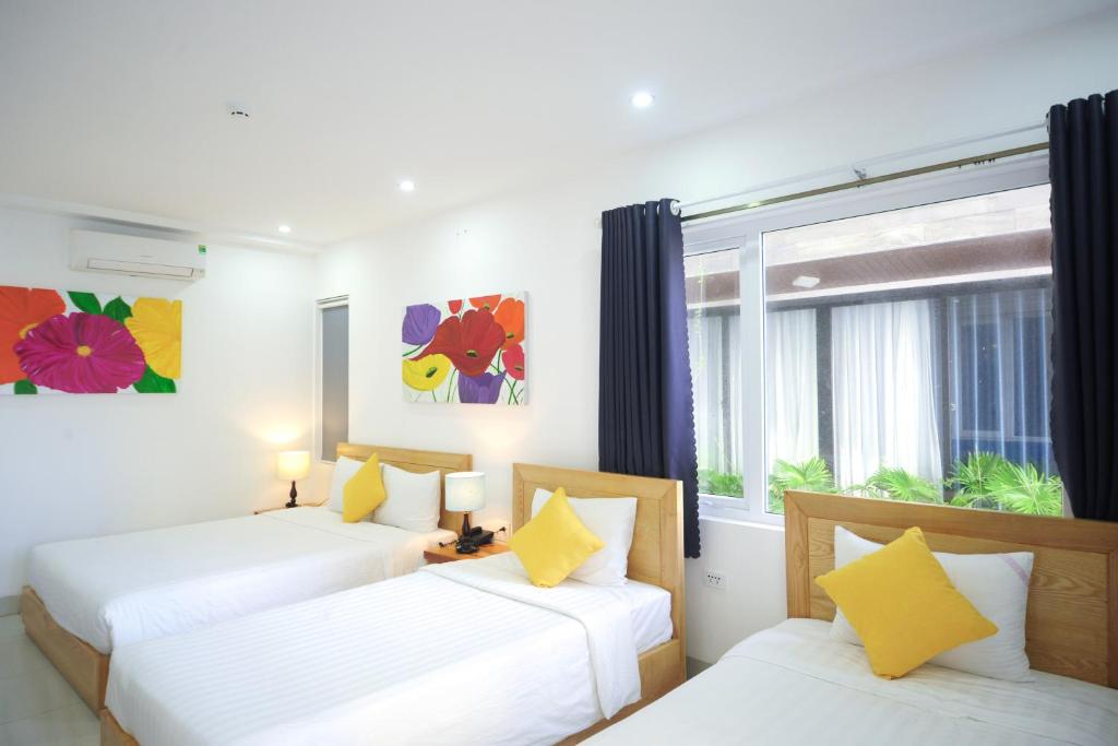 Giường trong phòng chung tại Cavilla Boutique Hotel & Apartment Da Nang