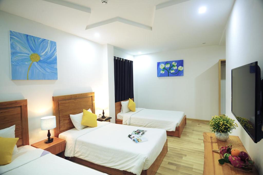 Postel nebo postele na pokoji v ubytování Cavilla Boutique Hotel & Apartment Da Nang