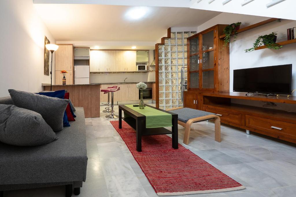 sala de estar con sofá y mesa de centro en Duplex La Corrala, en Cádiz