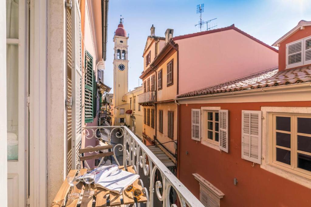 a balcony in a city with a clock tower at Philarmonic Orchestra Apartment by Konnect in Corfu Town