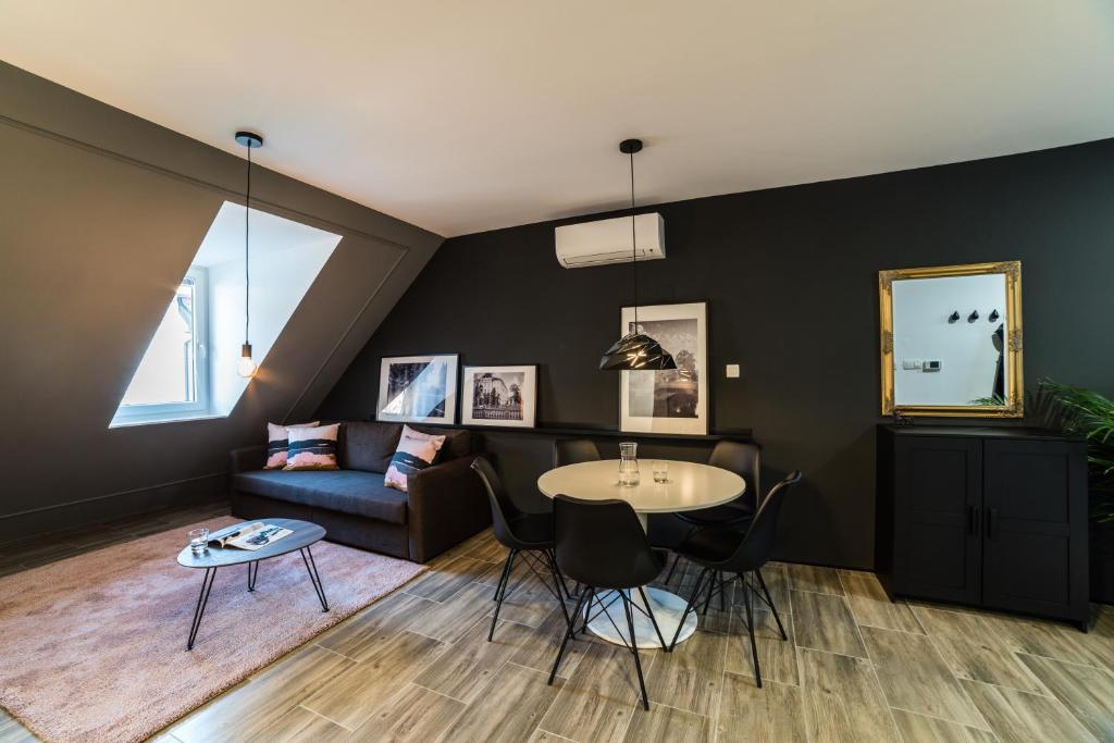 a living room with a couch and a table at Flex Apartments Tour As Ljubljana in Ljubljana