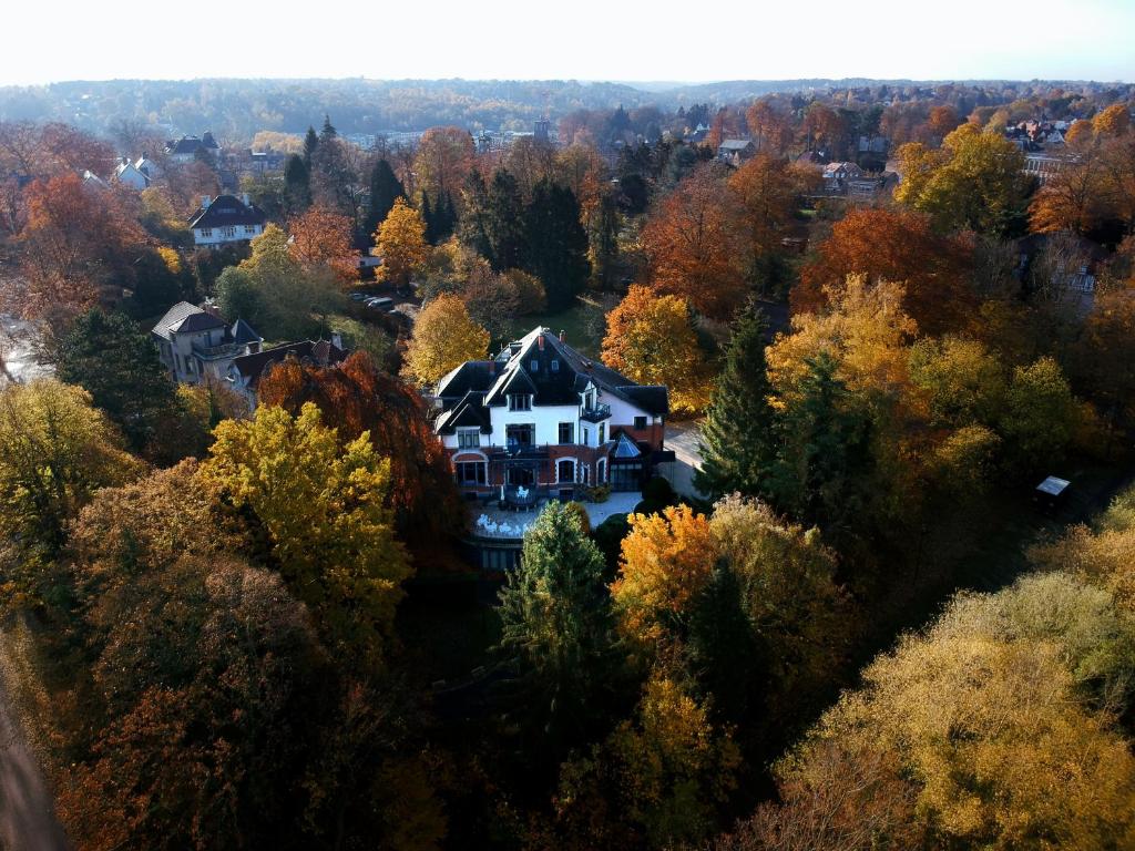 an aerial view of a house in the woods at Martin's Manoir in Genval