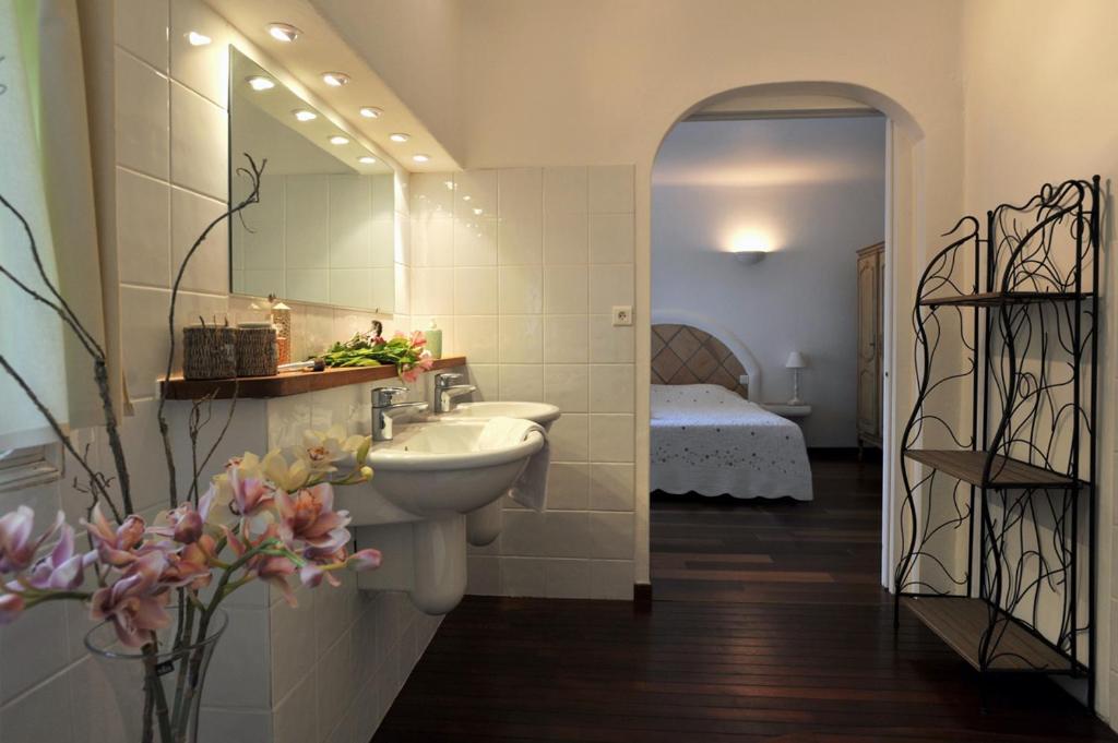 ポルト・ヴェッキオにあるDomaine Brellinga - Castedduのバスルーム(シンク、鏡、ベッド付)