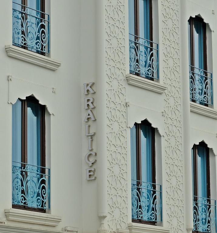 a white building with balconies and a sign on it at KRALICE HOTEL in Istanbul