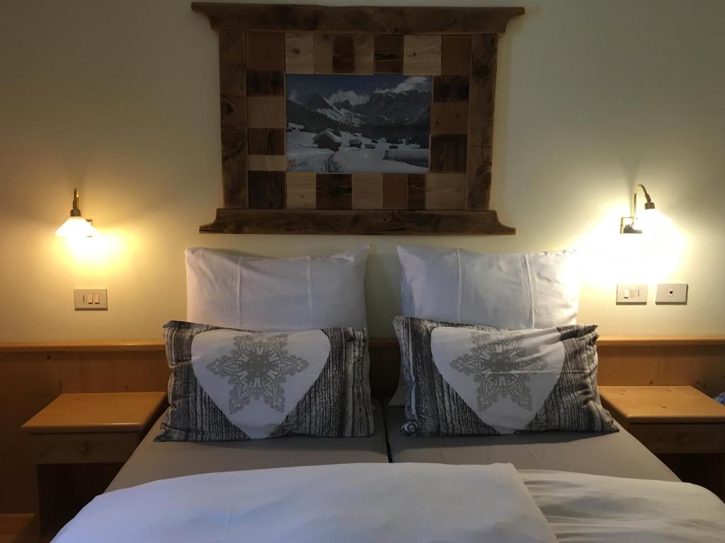 Llit o llits en una habitació de Appartamenti Chalet Orchidea