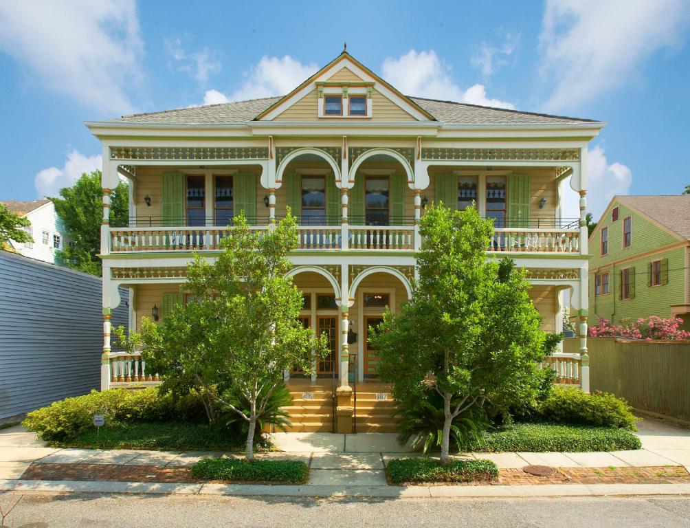 a large house with a balcony on top of it at Maison Perrier Bed & Breakfast in New Orleans