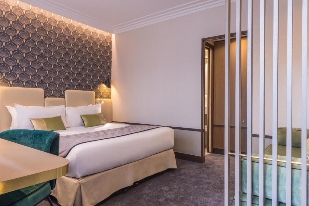 a hotel room with a bed and a chair at Best Western Select Hotel in Boulogne-Billancourt