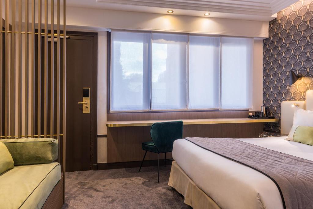 a hotel room with a bed and a desk and a window at Best Western Select Hotel in Boulogne-Billancourt