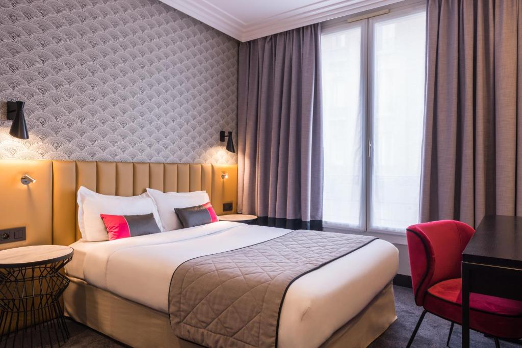 a hotel room with a bed and a red chair at Best Western Select Hotel in Boulogne-Billancourt