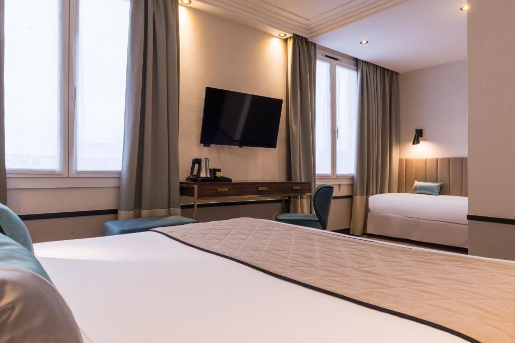 a hotel room with a bed and a television at Best Western Select Hotel in Boulogne-Billancourt