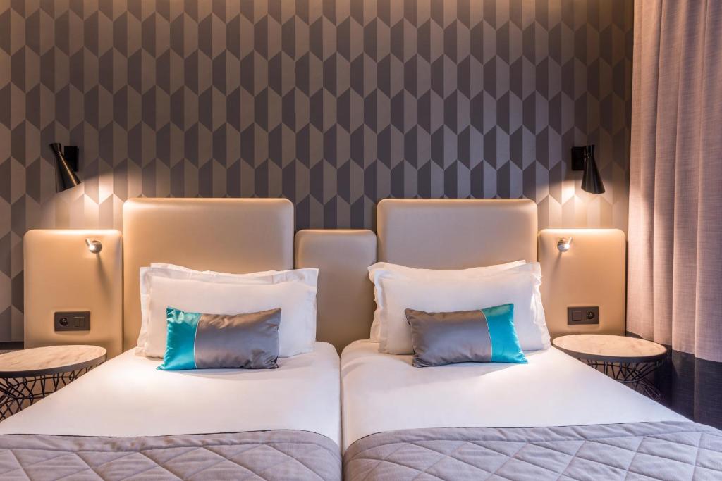 two beds with pillows sitting next to each other at Best Western Select Hotel in Boulogne-Billancourt