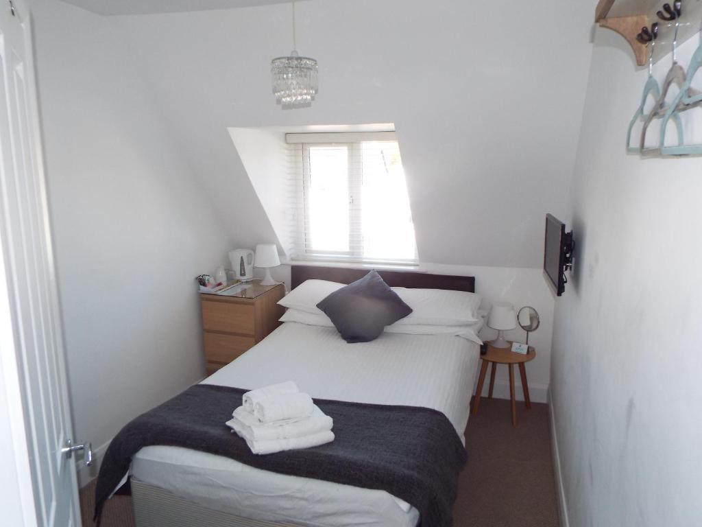 The Westby في بورنموث: غرفة نوم صغيرة بها سرير ونافذة