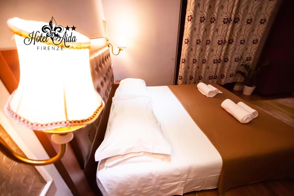 Postel nebo postele na pokoji v ubytování Hotel Aida