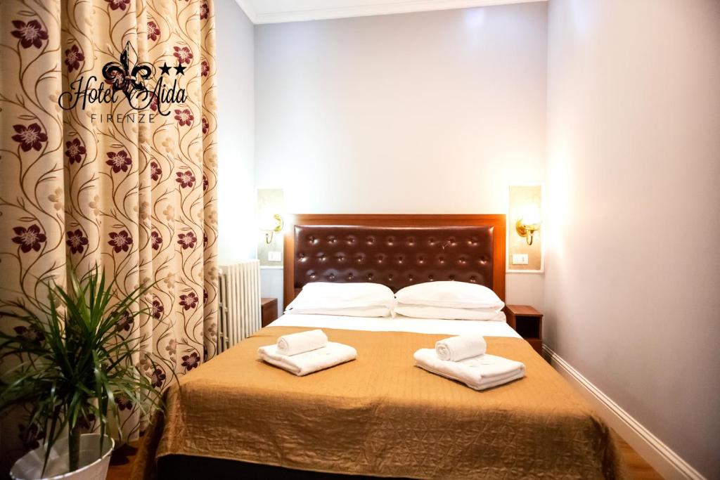 Postel nebo postele na pokoji v ubytování Hotel Aida