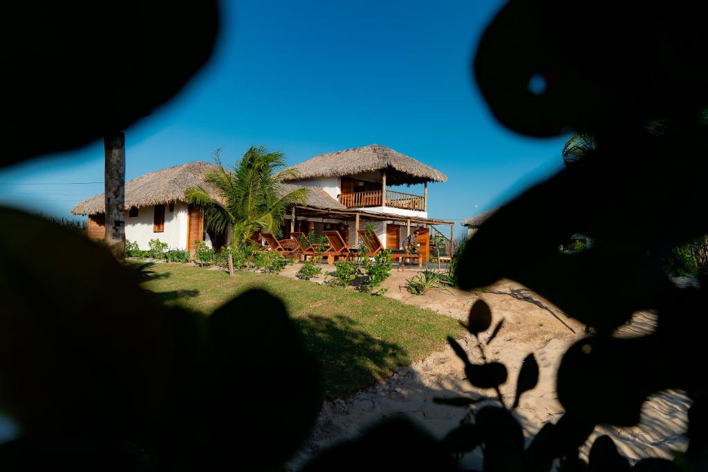a view of a house with a thatch roof at Villa Dunas by Preabeach Experience in Prea