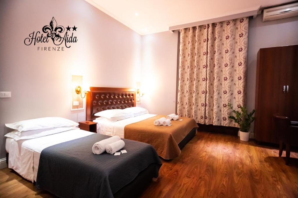 Postel nebo postele na pokoji v ubytování Hotel Aida