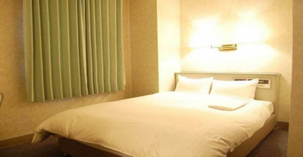 Säng eller sängar i ett rum på Seagrande Shimizu Station Hotel / Vacation STAY 8205