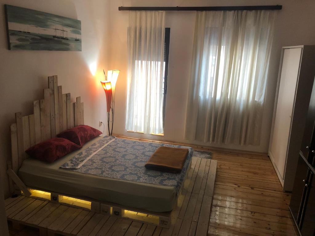 a bed in a room with a window at Central City Apartment in Belgrade