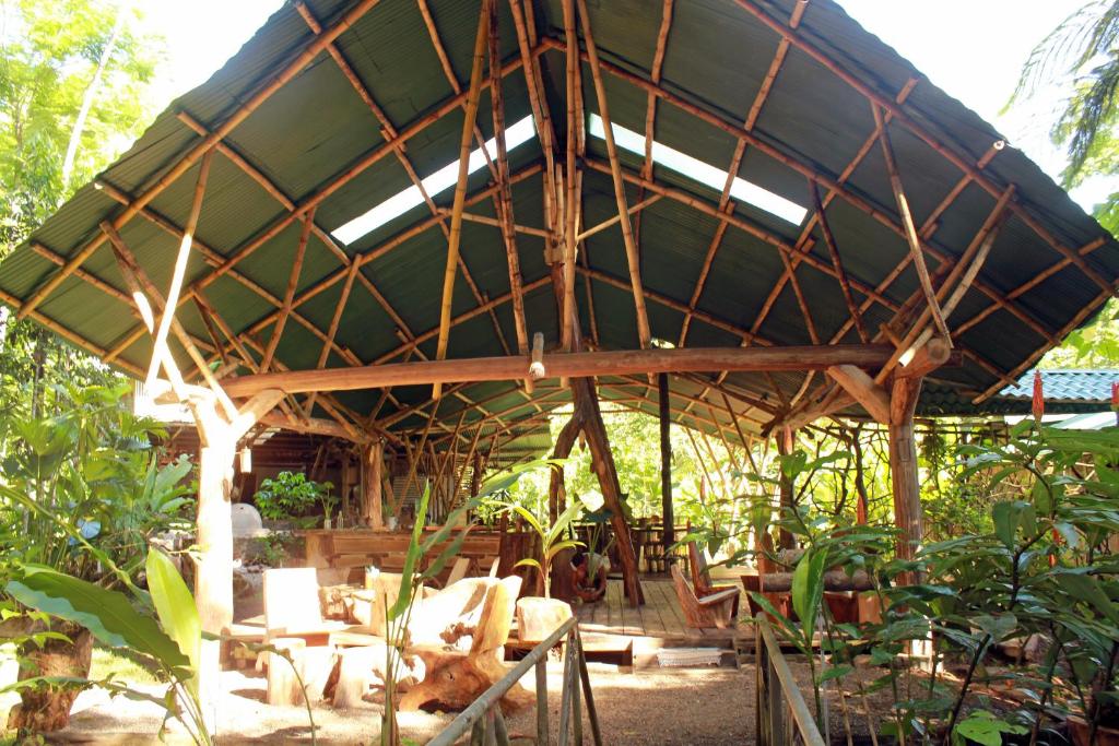 a large bamboo pavilion in a garden at Danta Corcovado Lodge in Rincón