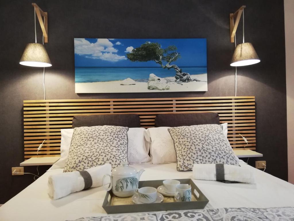 a bedroom with a white bed with a tray on it at B&B VICOLO STRETTO in Salerno