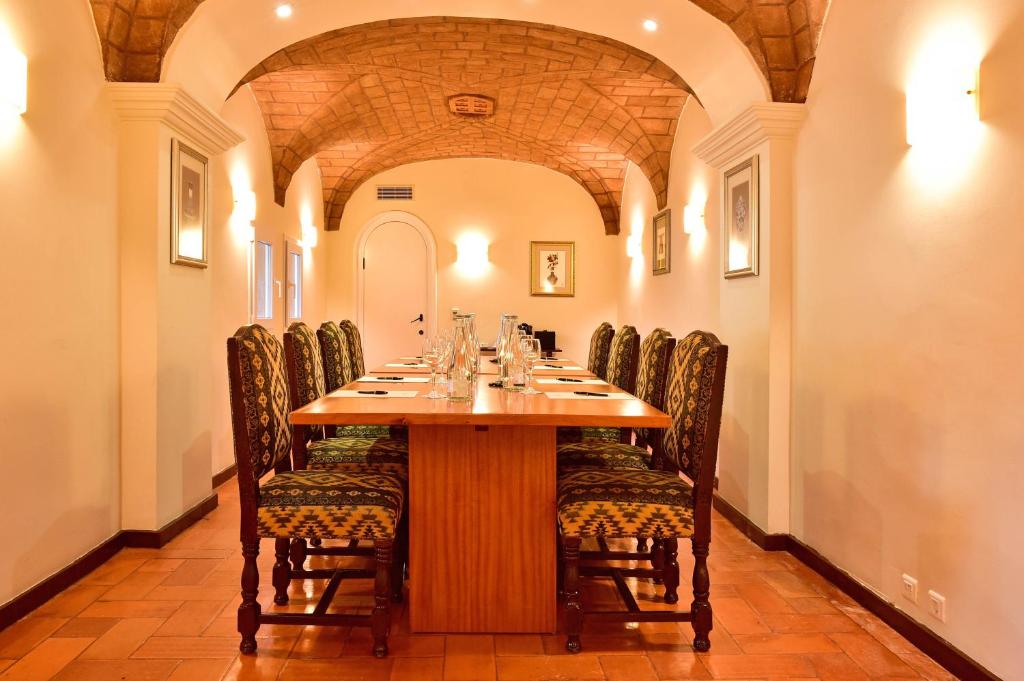 a dining room with a long table and chairs at Hotel Fortaleza do Guincho Relais & Châteaux in Cascais