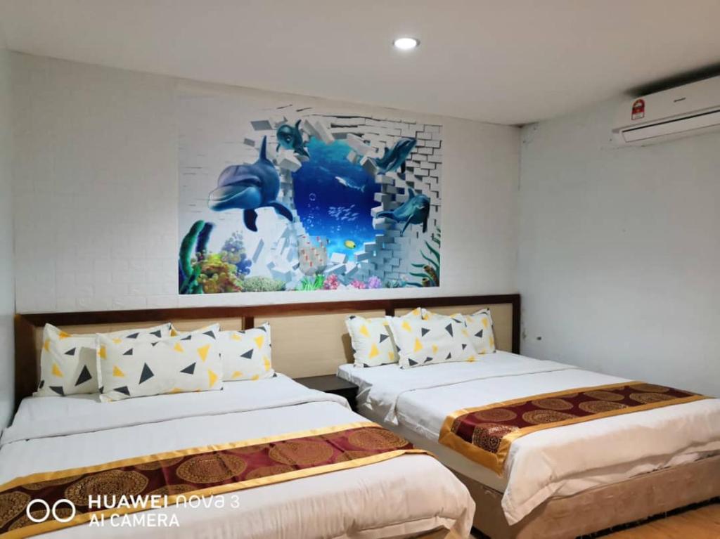 Postel nebo postele na pokoji v ubytování Mega Inn