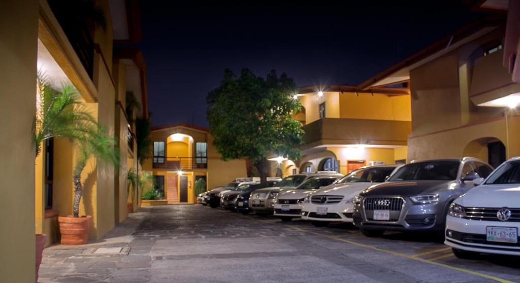 a row of cars parked in a parking lot at night at Hotel Ibiza in Veracruz