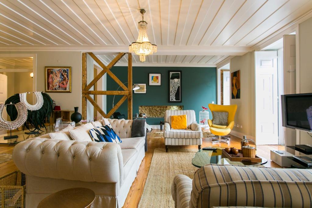 a living room with couches and a tv at Marchesa Da Bica Luxury in Lisbon