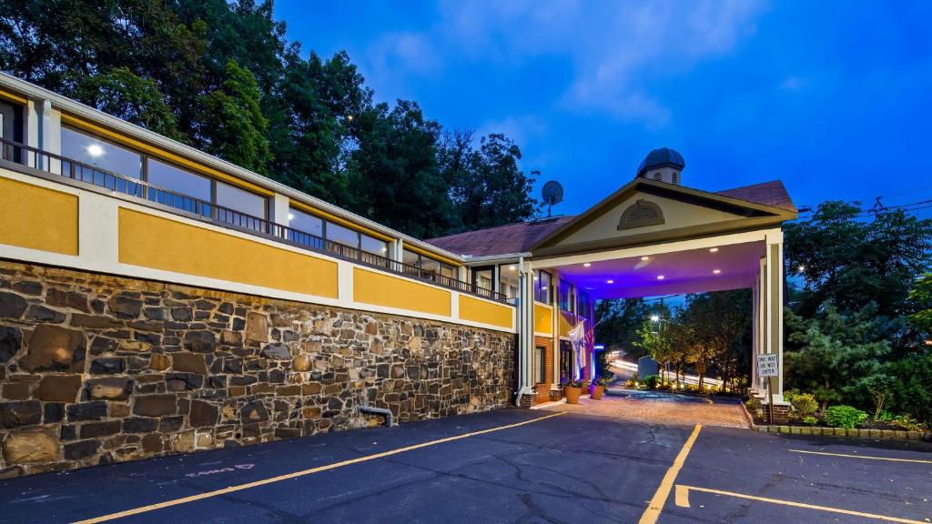 an empty parking lot in front of a building at Best Western Fort Lee in Fort Lee