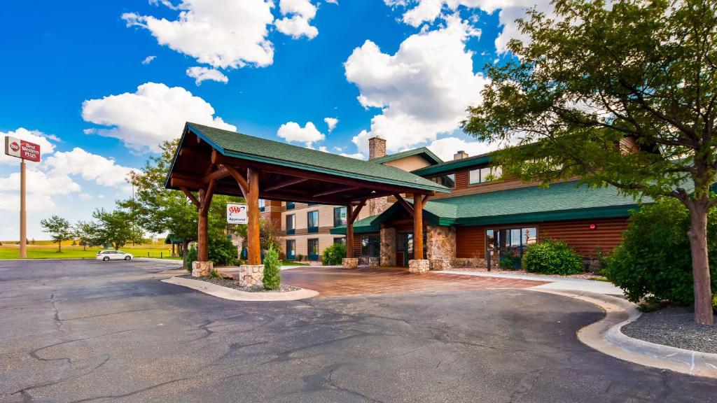 a parking lot in front of a building at Best Western Plus Sidney Lodge in Sidney