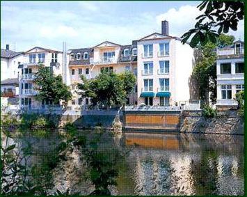 a group of buildings next to a body of water at Hotel Victoria in Bad Kreuznach