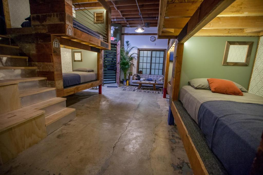 a bedroom with a bed and a bunk bed at PodShare Los Feliz in Los Angeles