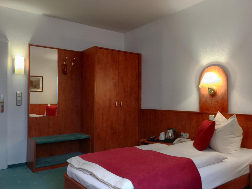 Postel nebo postele na pokoji v ubytování Hotel Hansa