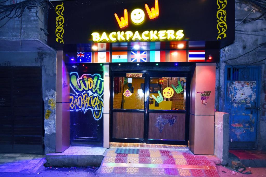 a door to a restaurant with a neon sign at Wow Backpackers Hostel in Amritsar
