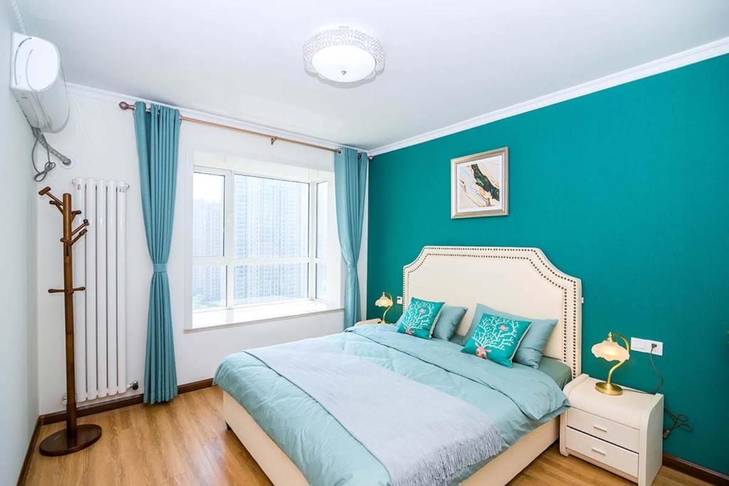 a blue bedroom with a bed and a window at Henan Luoyang·Henan University of Science And Technology· Locals Apartment 00150340 in Luoyang