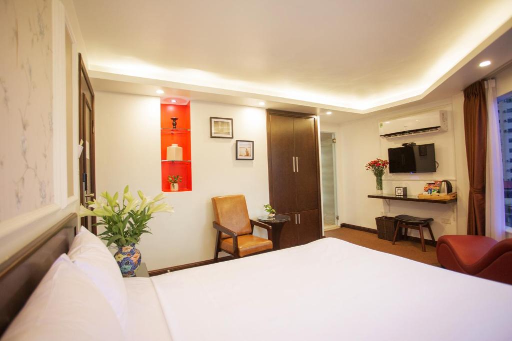 Postel nebo postele na pokoji v ubytování Dinh Hotel