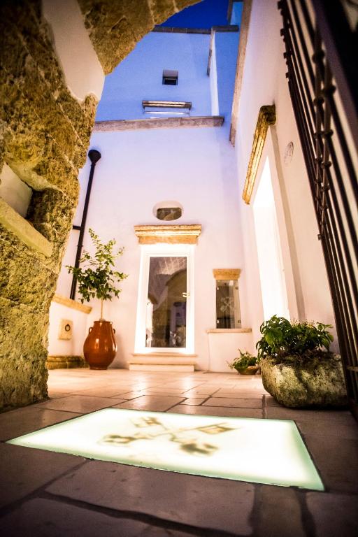 a hallway of a building with a rug on the floor at Corte di Bonifacio - Luxury Suites in Casarano