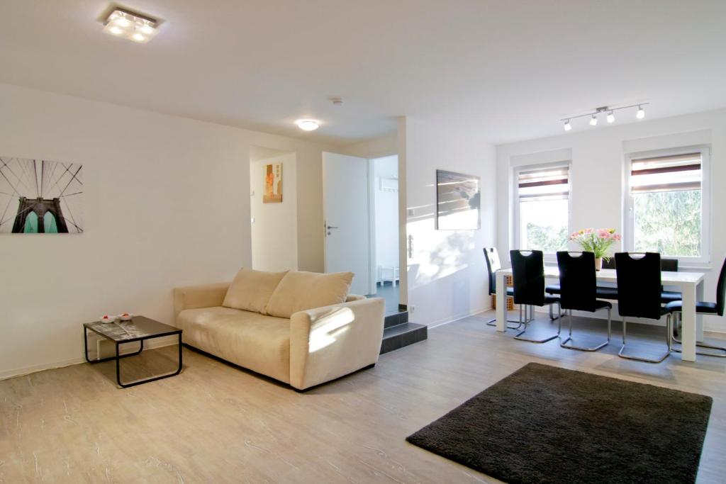 a living room with a couch and a table at apartmondo Ferienwohnungen Solingen in Solingen