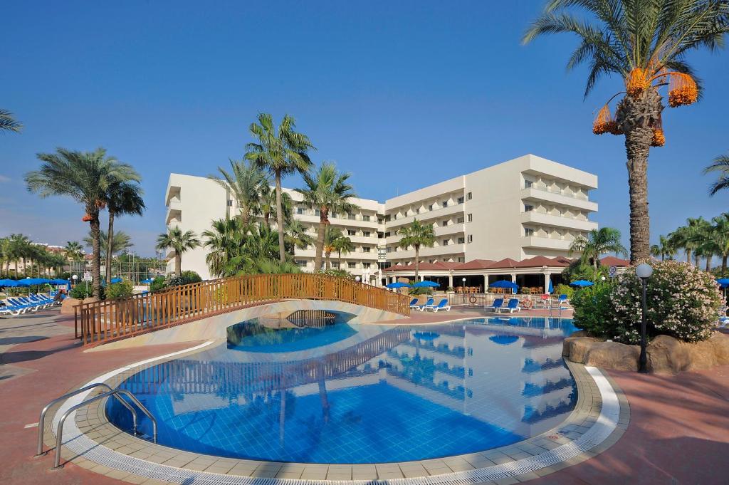 a swimming pool in front of a hotel at Nissiana Hotel & Bungalows in Ayia Napa