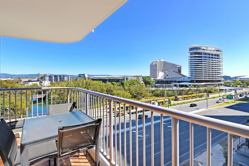 a balcony with a table and chairs and a city at Broadbeach Travel Inn Apartments in Gold Coast