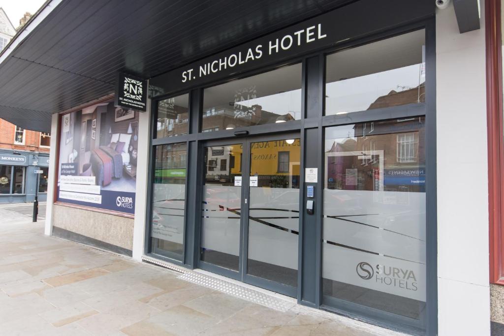 a store front with its doors open on a street at St Nicholas Hotel in Colchester