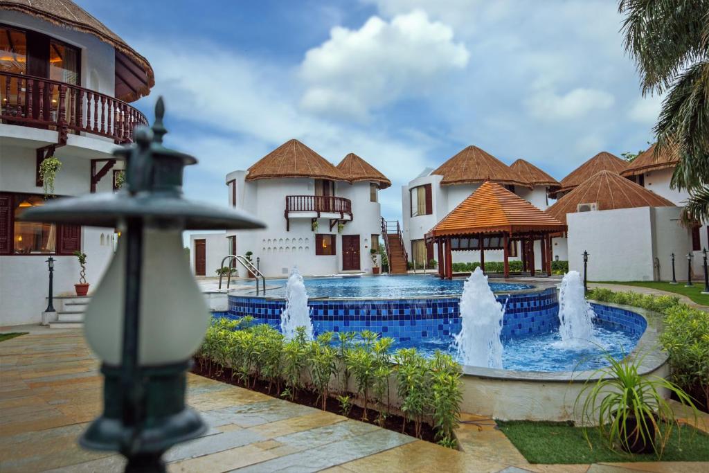 a fountain in the courtyard of a villa at Nirali Resorts in Rajkot