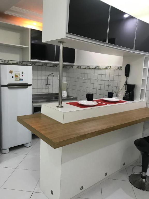 a kitchen with a counter with two plates on it at Apart KING BARRA in Salvador