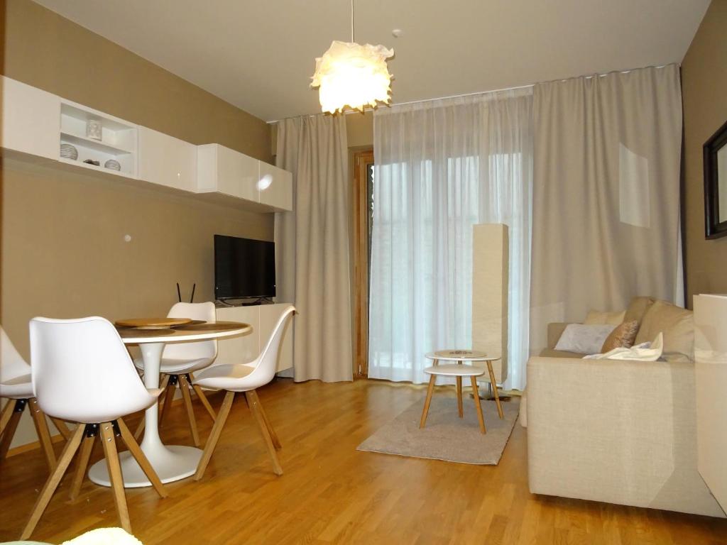a living room with a table and a couch at Medvědín Apartmán 106 in Špindlerův Mlýn