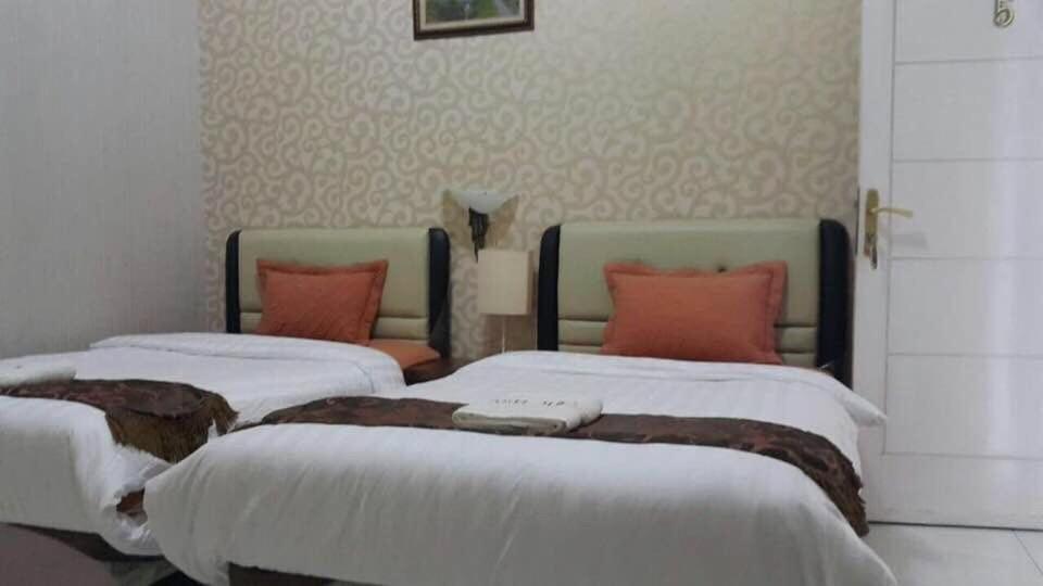 Postel nebo postele na pokoji v ubytování Hotel Alifa Syariah