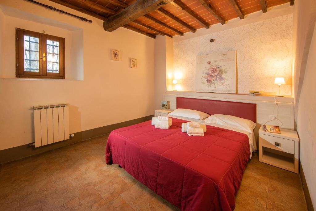 A bed or beds in a room at Villa Norcenni ApartHotel