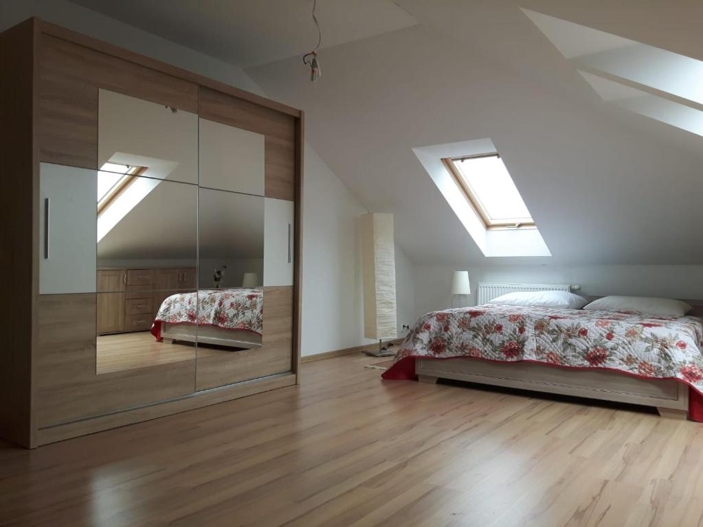 a bedroom with a bed and a large mirror at Osiedle Baltyk in Grzybowo