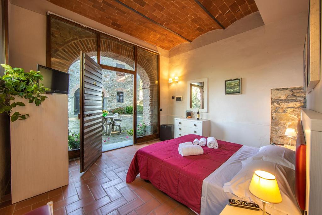 A bed or beds in a room at Villa Norcenni ApartHotel